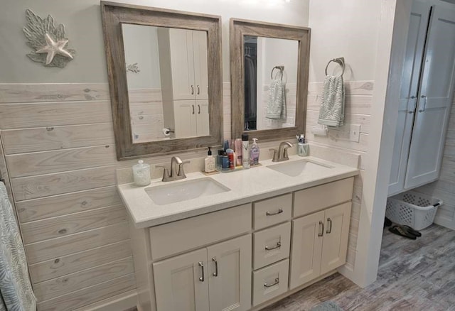 517 Private Road 675, Sargent, TX 77414 - full bath with double vanity, a sink, and wood finished floors