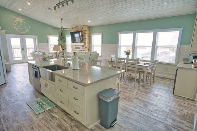 517 Private Road 675, Sargent, TX 77414 - kitchen with stainless steel dishwasher, a sink, wooden ceiling, white cabinets, and light wood finished floors