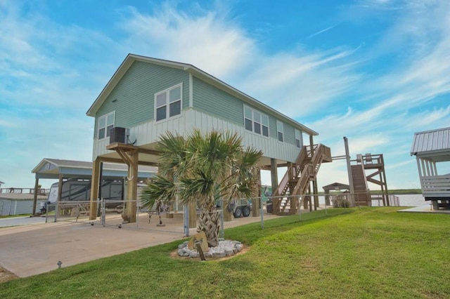 517 Private Road 675, Sargent, TX 77414 - rear view of house with a lawn, central AC, and stairway