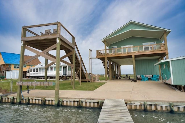 517 Private Road 675, Sargent, TX 77414 - rear view of house featuring stairs, a deck with water view, board and batten siding, a shed, and an outdoor structure