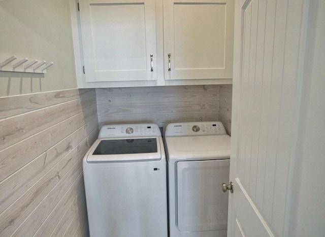 517 Private Road 675, Sargent, TX 77414 - laundry area featuring cabinet space, wood walls, and washing machine and dryer