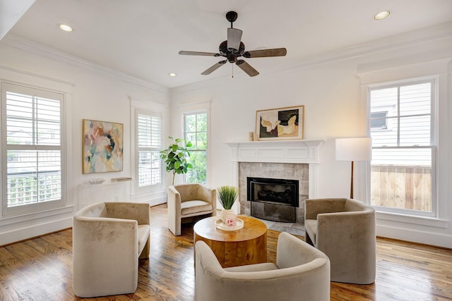 806 Waverly St, Houston, TX 77007 - living room with a tiled fireplace, ornamental molding, a ceiling fan, and wood finished floors