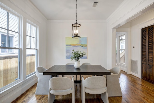 806 Waverly St, Houston, TX 77007 - dining space with an inviting chandelier, wood finished floors, and visible vents