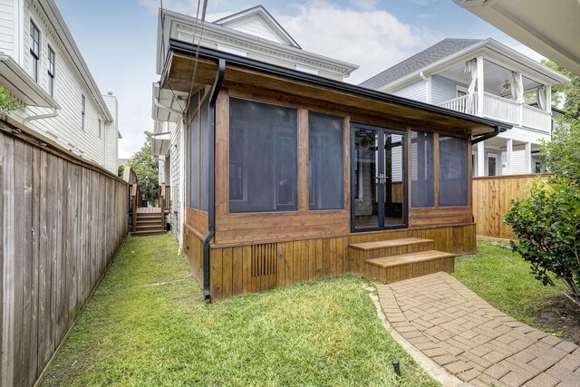 806 Waverly St, Houston, TX 77007 - rear view of property featuring a sunroom, a lawn, fence, and entry steps