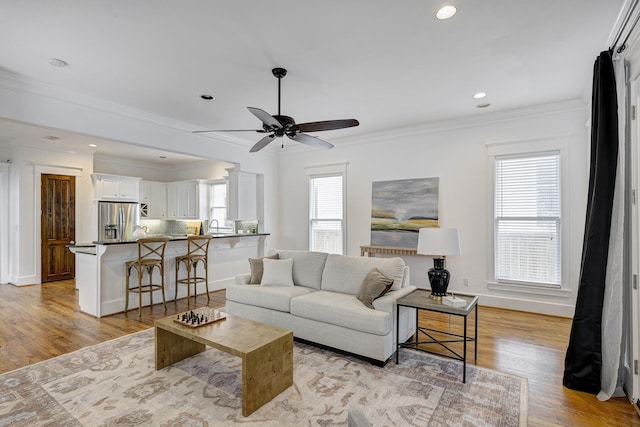 806 Waverly St, Houston, TX 77007 - living area with ceiling fan, light wood finished floors, recessed lighting, baseboards, and ornamental molding