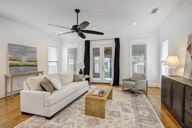 806 Waverly St, Houston, TX 77007 - living area with visible vents, crown molding, a wealth of natural light, and light wood-type flooring