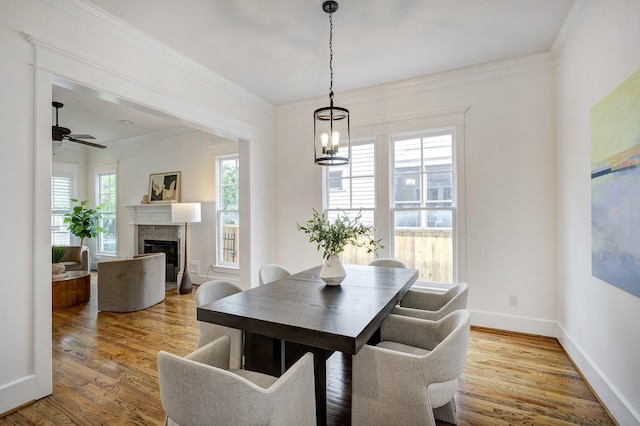 806 Waverly St, Houston, TX 77007 - dining room with a glass covered fireplace, a ceiling fan, baseboards, wood finished floors, and ornamental molding