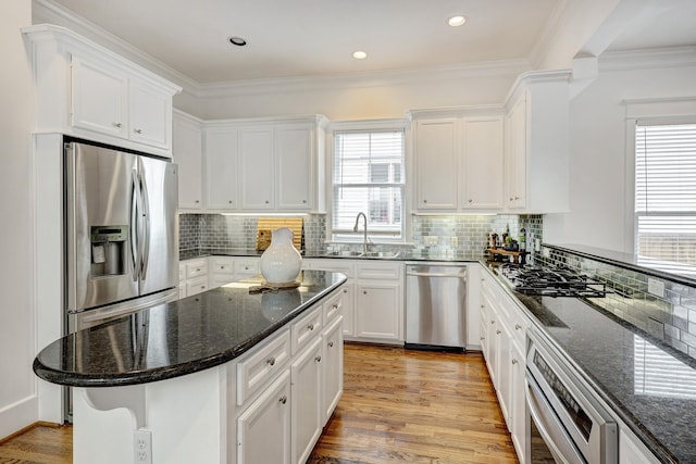 806 Waverly St, Houston, TX 77007 - kitchen with white cabinets, appliances with stainless steel finishes, and a sink