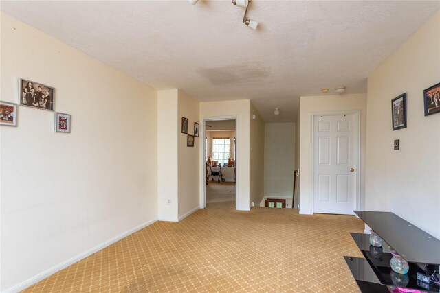 interior space featuring carpet floors and baseboards