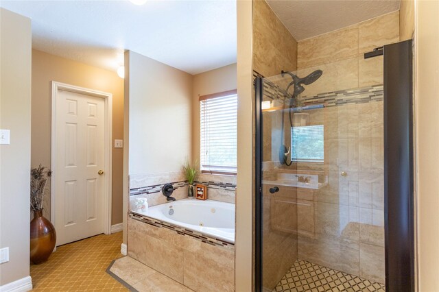 full bathroom featuring baseboards, a shower stall, and a jetted tub