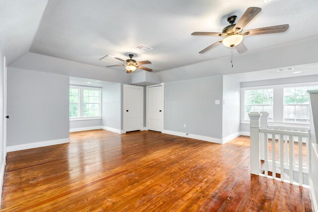 interior space with vaulted ceiling, a ceiling fan, and hardwood / wood-style flooring