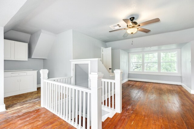 bonus room featuring baseboards, visible vents, ceiling fan, and hardwood / wood-style flooring