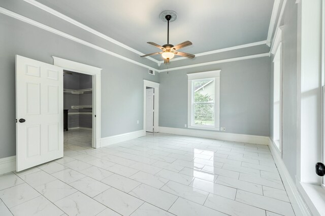 empty room featuring a ceiling fan, visible vents, baseboards, marble finish floor, and ornamental molding