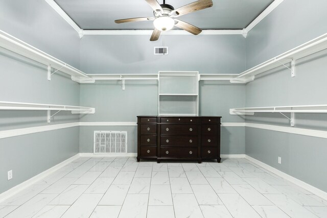 spacious closet featuring a ceiling fan, visible vents, and marble finish floor