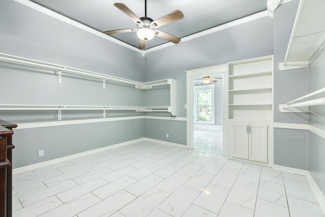 walk in closet featuring a ceiling fan and marble finish floor