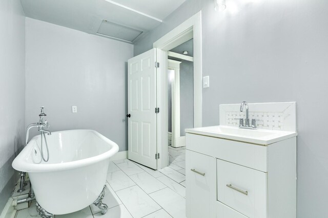 full bath with a freestanding bath, marble finish floor, and vanity