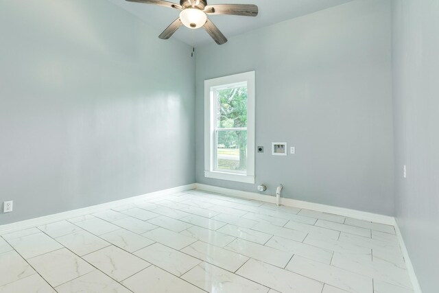 spare room featuring baseboards, ceiling fan, and marble finish floor