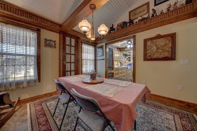 dining room featuring baseboards, ceiling fan with notable chandelier, and wood finished floors