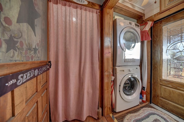 washroom with stacked washer / drying machine and laundry area