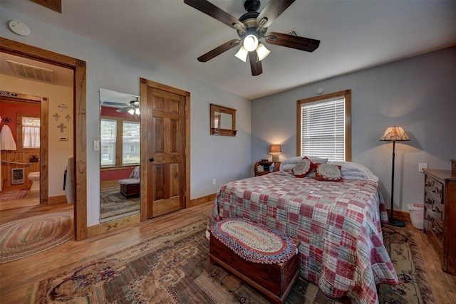 bedroom with visible vents, baseboards, ceiling fan, and wood finished floors