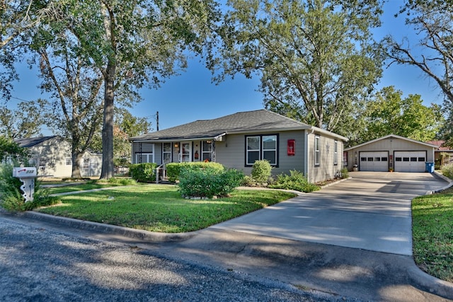 bungalow with an outbuilding, a front yard, and a detached garage