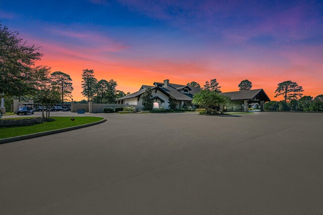 view of front of home featuring fence and a carport