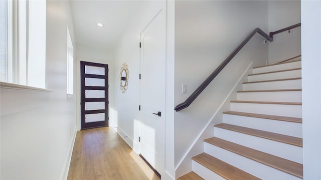 interior space featuring recessed lighting, baseboards, and wood finished floors