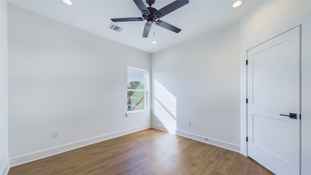 spare room with a ceiling fan, recessed lighting, wood finished floors, and visible vents