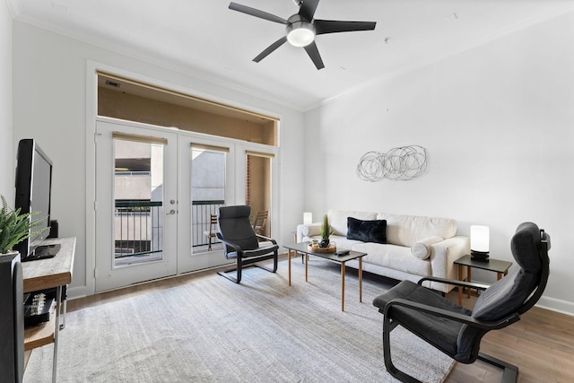 living room featuring ornamental molding, french doors, ceiling fan, and wood finished floors