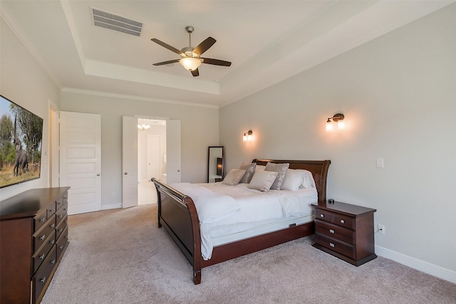 bedroom featuring a tray ceiling, carpet flooring, and baseboards