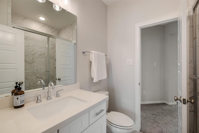 bathroom with a shower stall, vanity, toilet, and baseboards