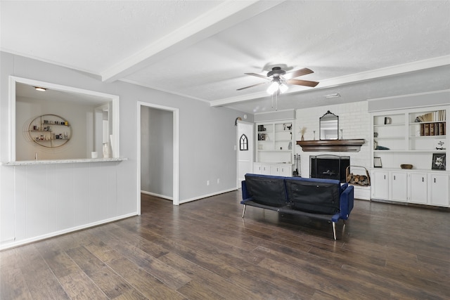 living room featuring ceiling fan, a textured ceiling, wood finished floors, baseboards, and beamed ceiling