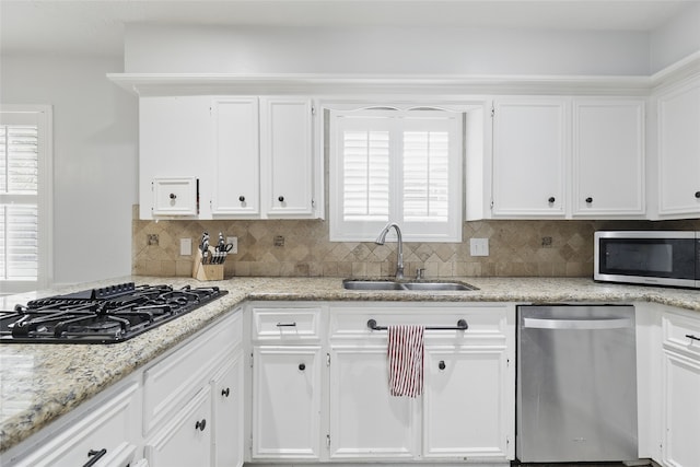 kitchen with a sink, white cabinetry, and appliances with stainless steel finishes