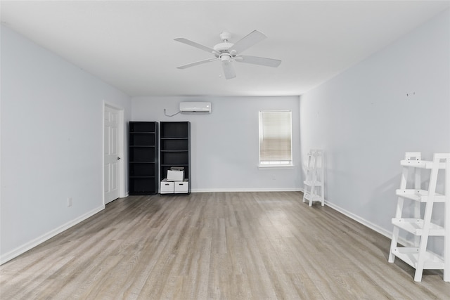 unfurnished room with baseboards, a wall mounted air conditioner, ceiling fan, and wood finished floors