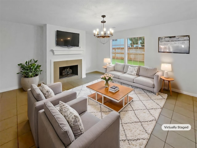 tiled living room featuring baseboards, a chandelier, and a fireplace