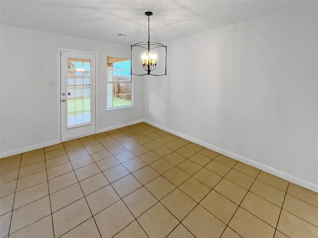 unfurnished dining area with baseboards, light tile patterned flooring, a notable chandelier, and visible vents