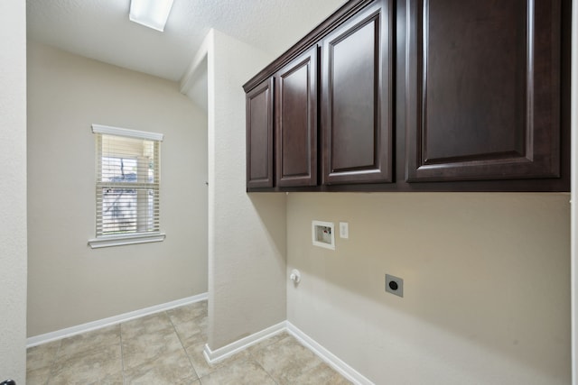 clothes washing area with hookup for an electric dryer, cabinet space, washer hookup, baseboards, and light tile patterned flooring