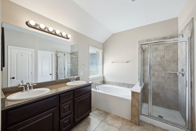 full bathroom with a shower stall, vaulted ceiling, a garden tub, double vanity, and tile patterned flooring