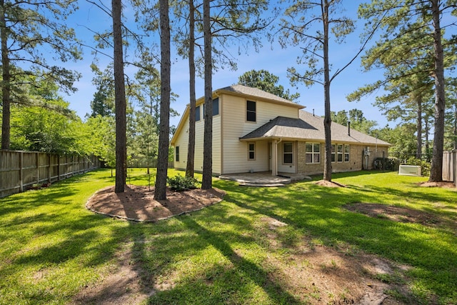 rear view of property featuring a patio area, roof with shingles, and brick siding