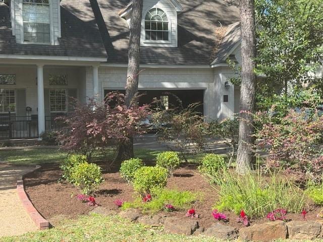 view of home's exterior with a garage and a porch