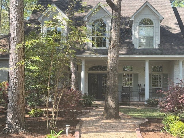 view of front of home featuring a porch and brick siding