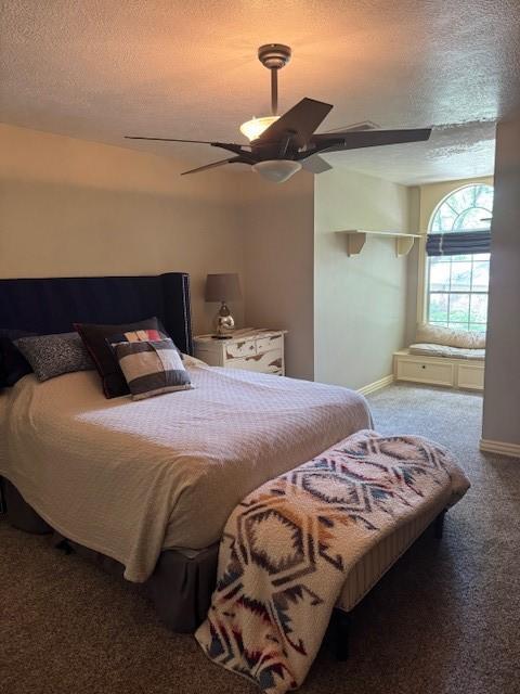 bedroom featuring baseboards, a ceiling fan, carpet flooring, and a textured ceiling