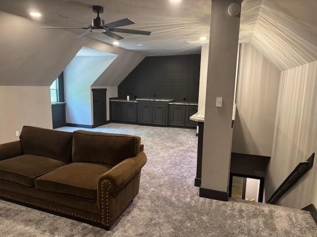 additional living space with light colored carpet, a ceiling fan, lofted ceiling, and recessed lighting