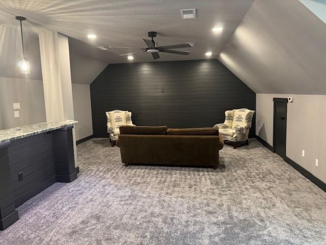 interior space featuring baseboards, ceiling fan, lofted ceiling, and visible vents
