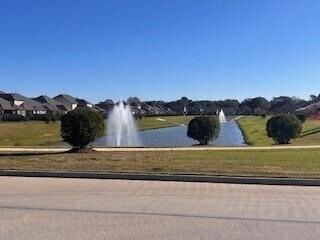 view of home's community with a water view