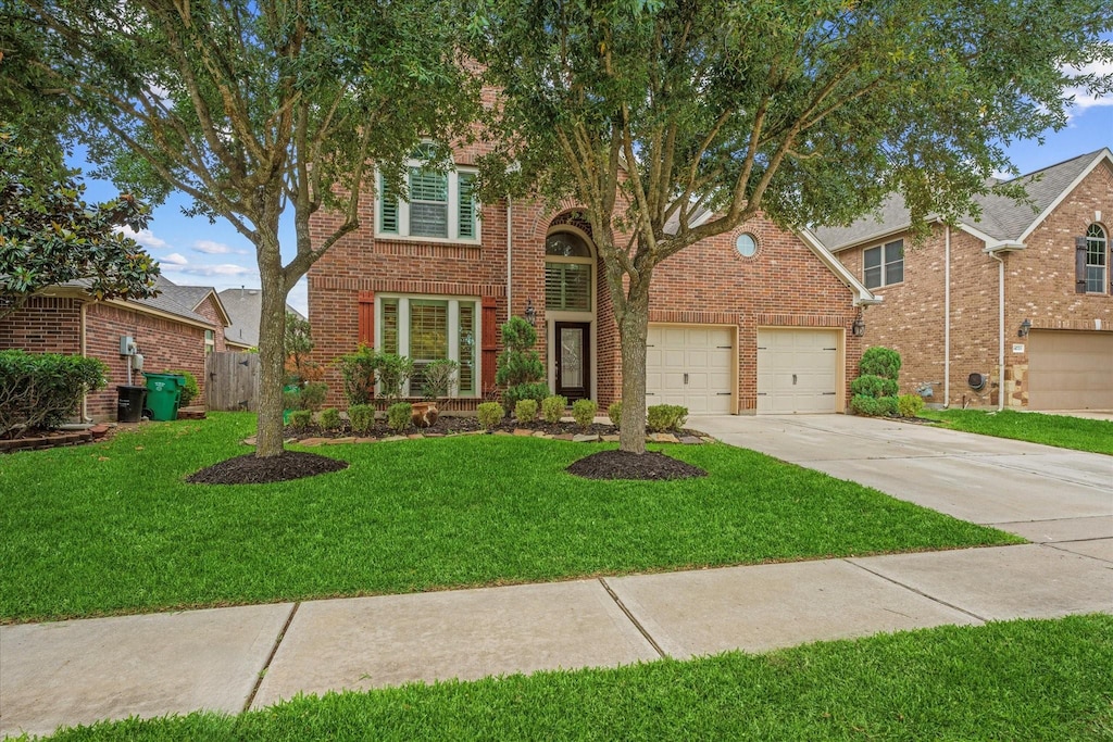 14719 Yellow Begonia Dr, Cypress, TX 77433 - view of front of home with brick siding, concrete driveway, and a garage