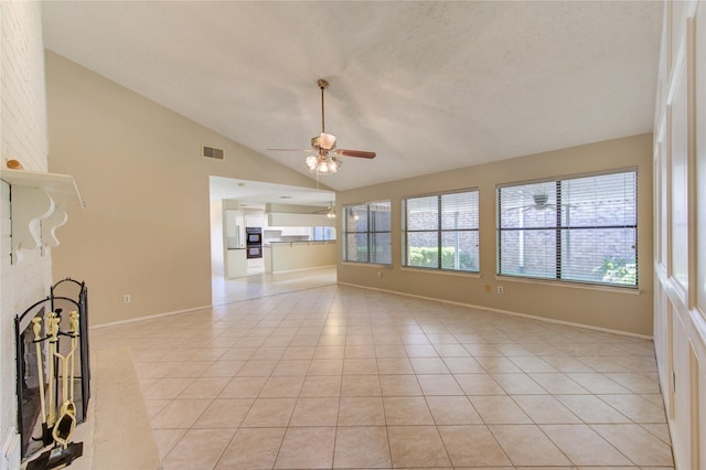 unfurnished living room with visible vents, baseboards, a ceiling fan, light tile patterned floors, and vaulted ceiling