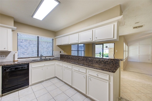 kitchen featuring a sink, light tile patterned floors, a peninsula, and dishwasher