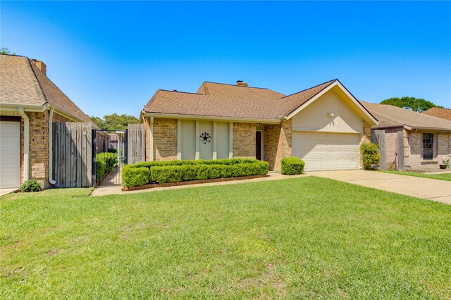single story home with a garage, fence, a front yard, brick siding, and driveway