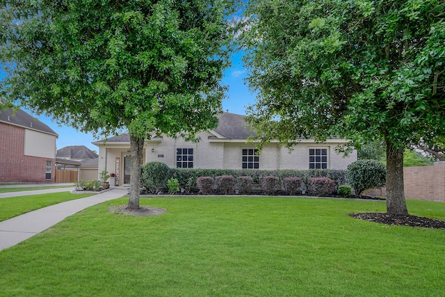 view of front of property featuring brick siding and a front yard
